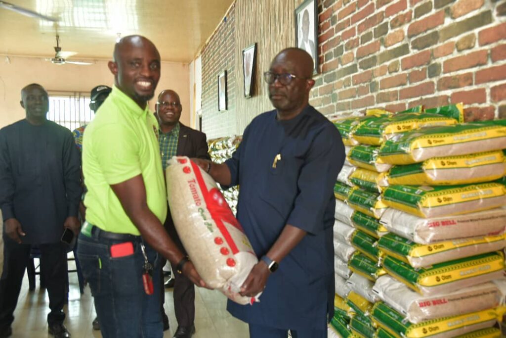 Etinan council chairman, Uko Umoh presents bags of rice to LG staff